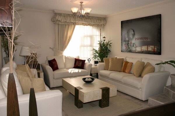 Bright living room with white furniture and light curtains