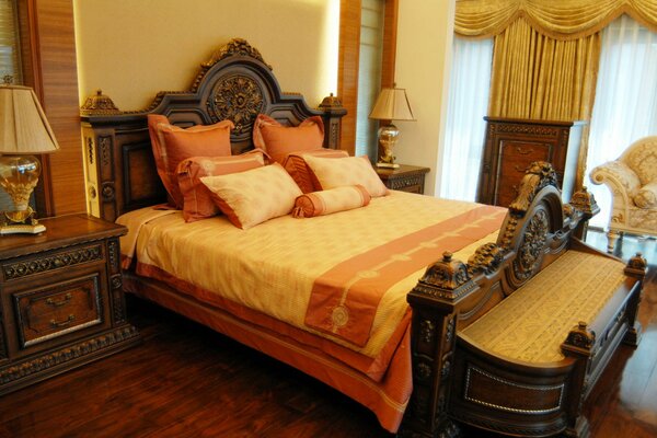 Bedroom interior with a large bed, pillows and beautiful lamps