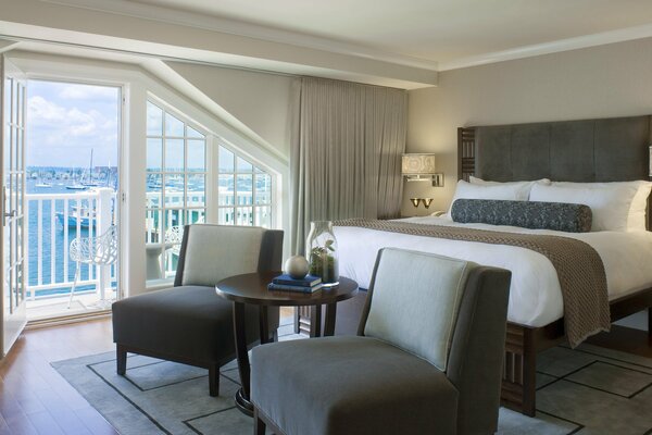 There is a chic bedroom with a beautiful design with a sea view