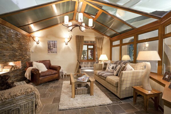 Cozy living room with fireplace under the roof of the house