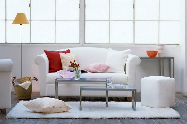 Cozy design of the living room with ottomans and pillows