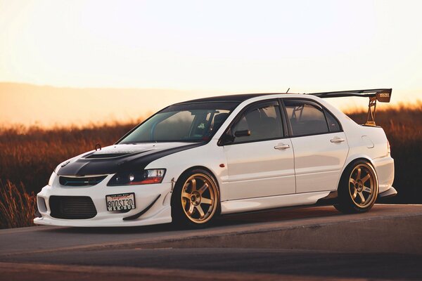 Mitsubishi lancer evo white at sunset