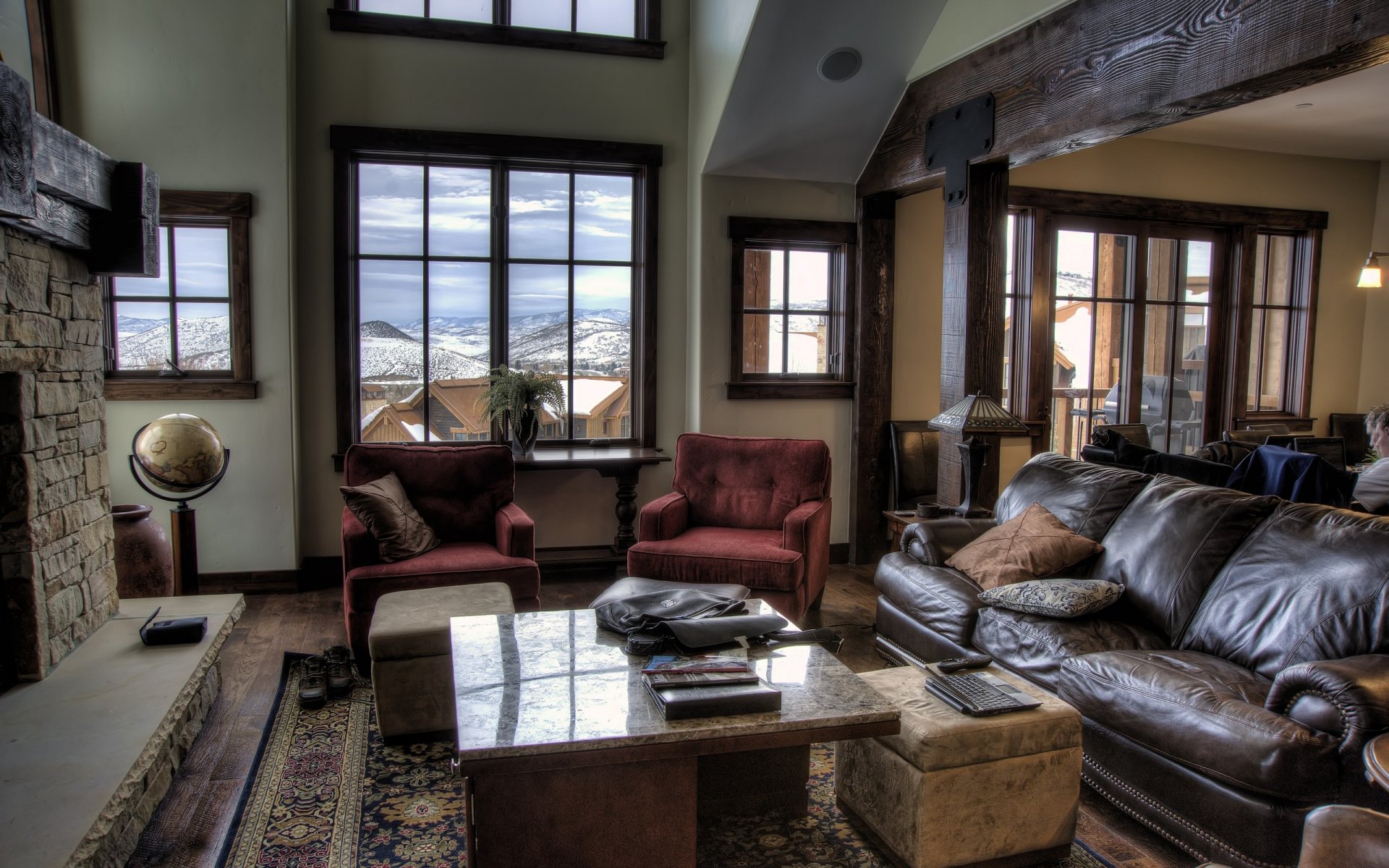 interior design armchairs table sofa fireplace somewhere in the mountain