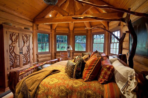 The interior of the bedroom is made of wood with a cozy bed