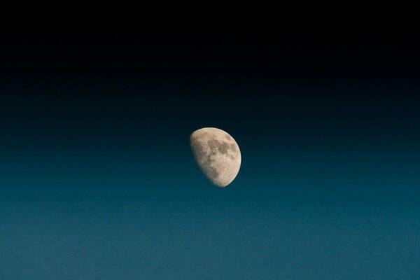 The indescribable beauty of the moon in the blue sky