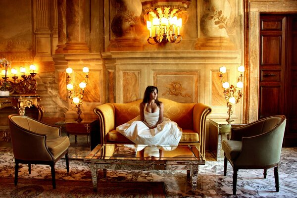 Brunette girl in a white dress in a castle