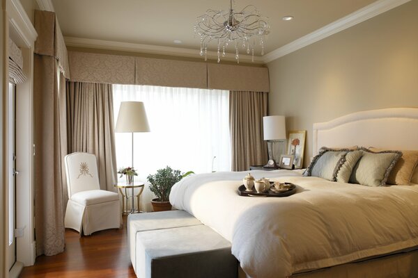 Beautiful bedroom with curtains and a magnificent chandelier