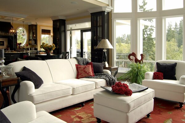 Red pillows and carpet with light sofas