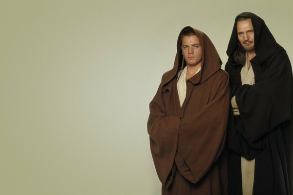 Two Jedi in robes on a light background