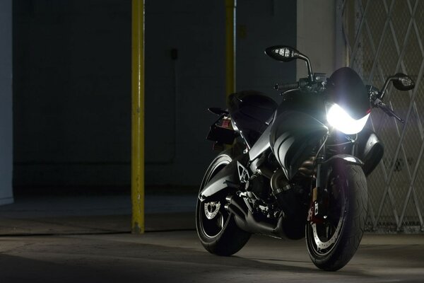 Black buell motorcycle with headlight on