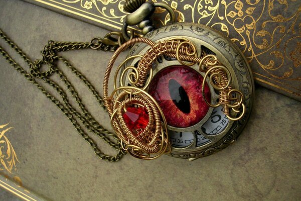 Golden steampunk watch with curlicues and dragon eye