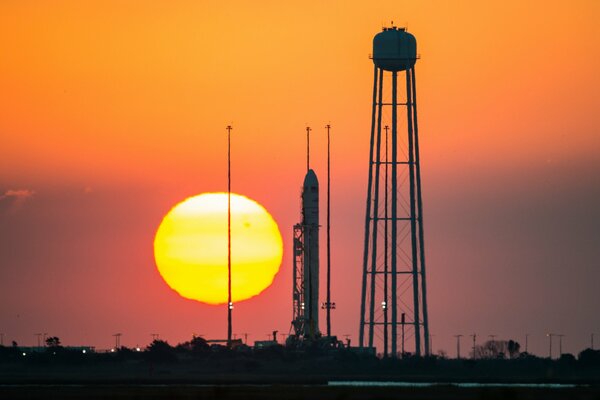 Space buildings on the background of an orange sunset