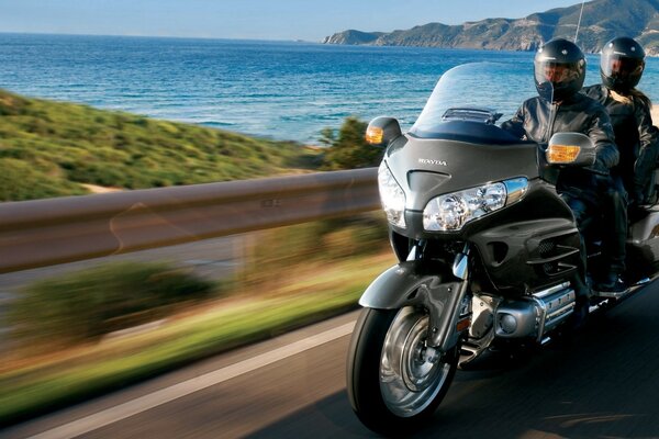 Motorcycle bomber on the road with two people