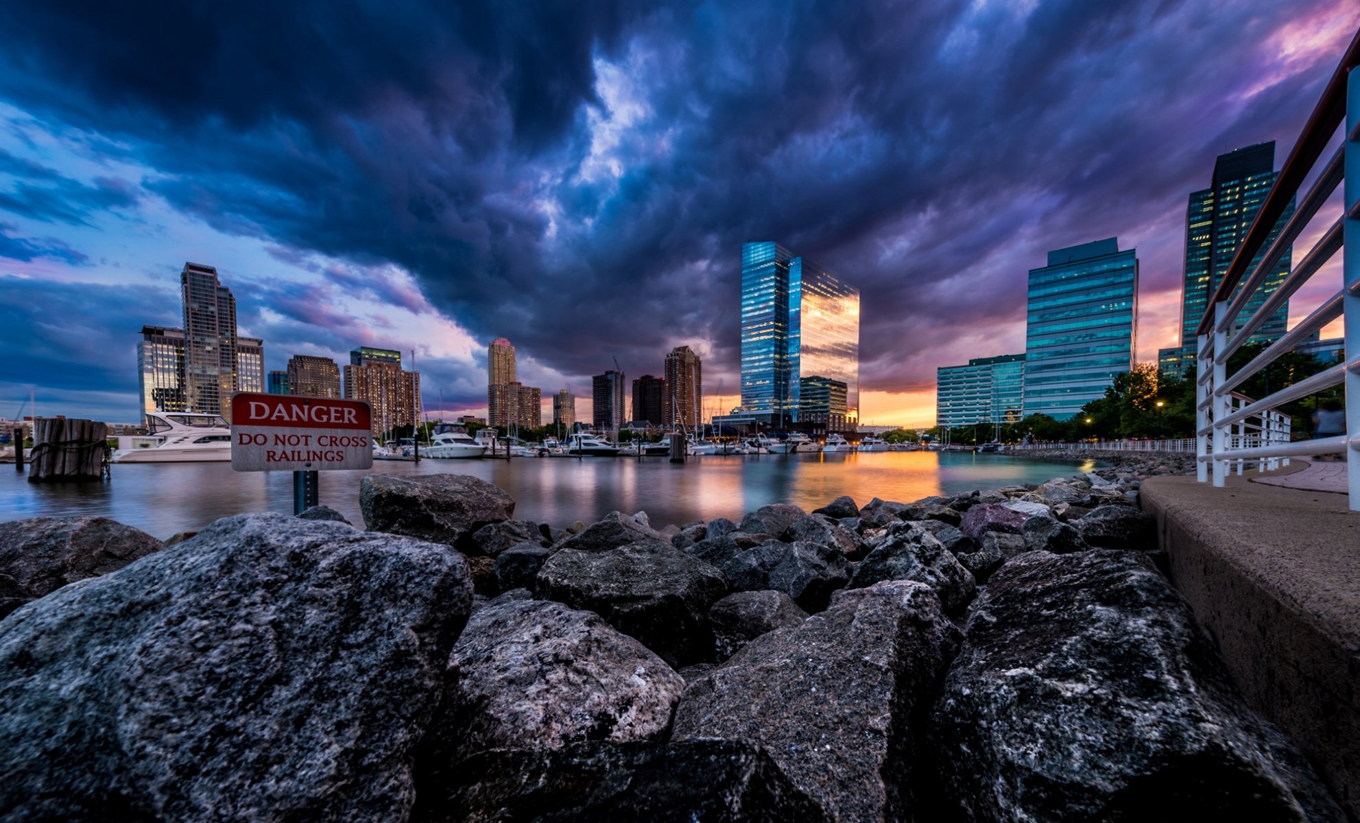 usa new jersey state city skyscrapers evening sky sunset boats rocks shore river