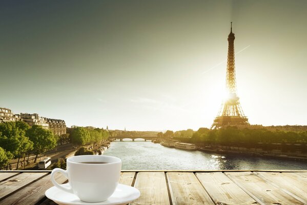 A cup of coffee with a view of the Eiffel Tower