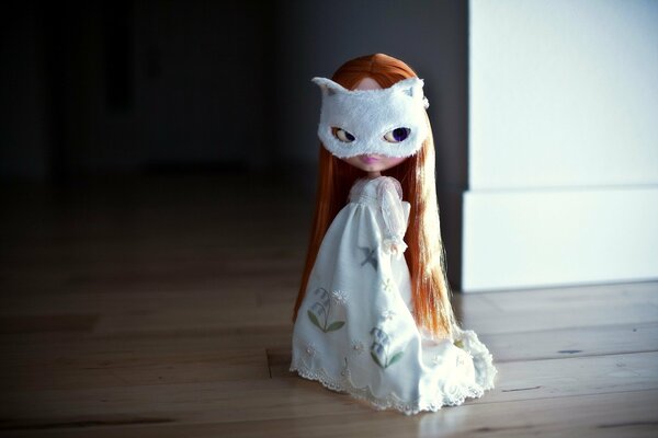 A ghost doll with red hair in a mysterious mask