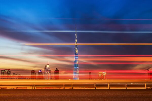 Photo with an excerpt. Dubai in the evening, the light is on in the tower