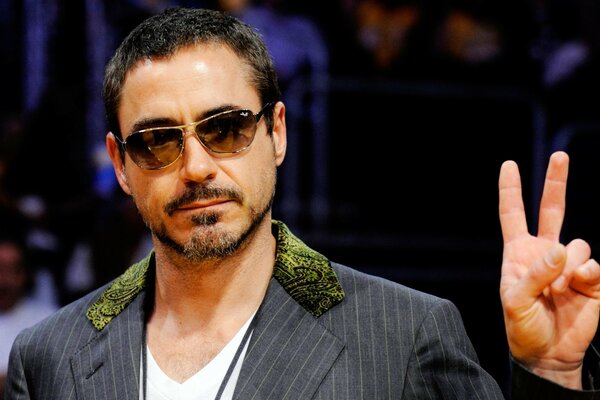 Robert Downey Jr. wearing glasses and a suit