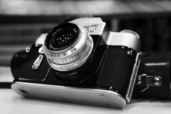 black and white photo of the Zenit camera with a lens