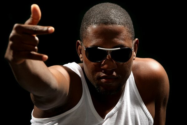 A man with glasses and a white T-shirt