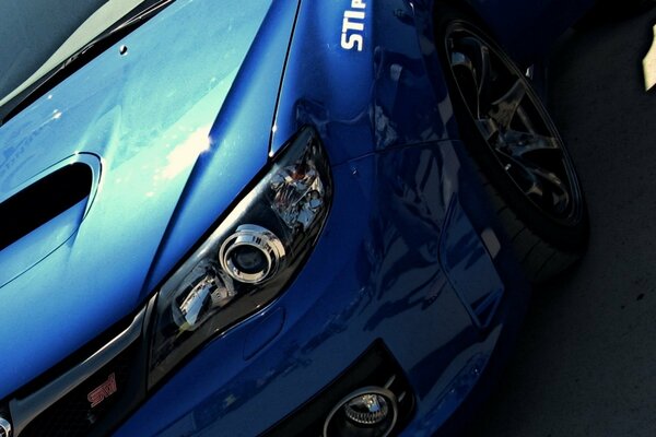 Part with a blue Subaru impreza headlight