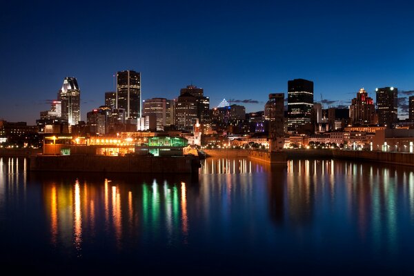 The lights are reflected in the night water