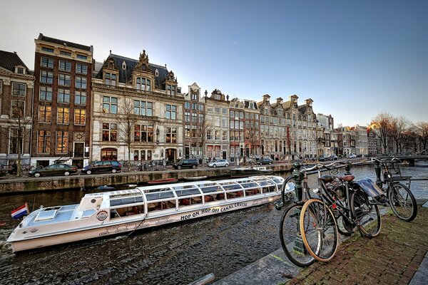 Amsterdam bicycles on the cobblestones by the river