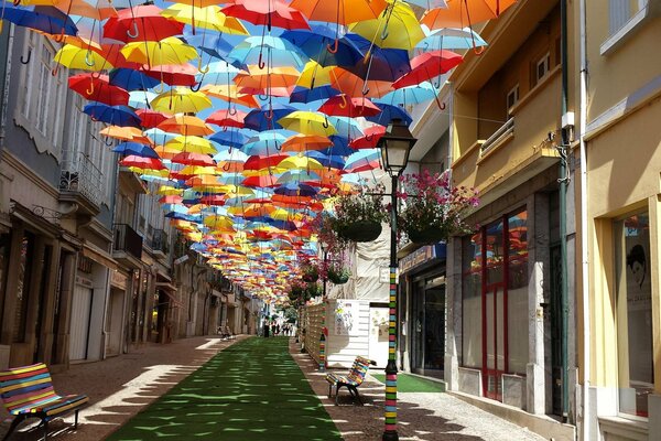 Summer Portugal. A street surrounded by houses and umbrellas