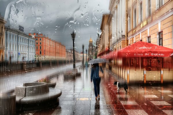 A girl under an umbrella on the embankment of St. Petersburg