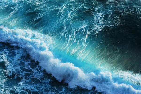 Turquoise-blue sea waves with foam