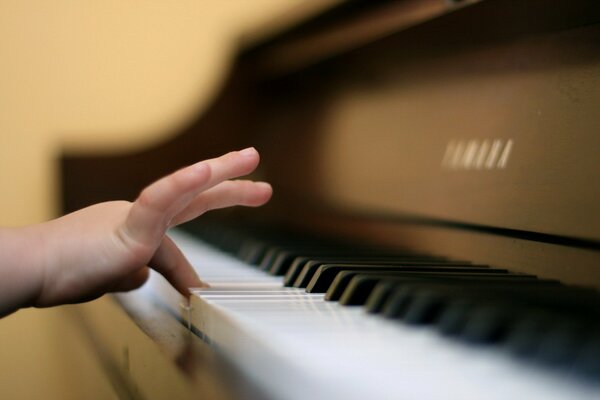 A child learns to play the piano