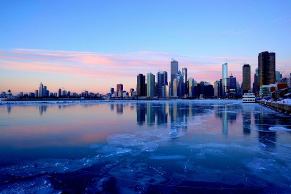 Winter river with a view of the city s skyscrapers