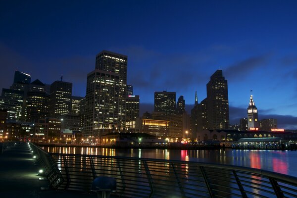 Embankment at night with high-rise buildings