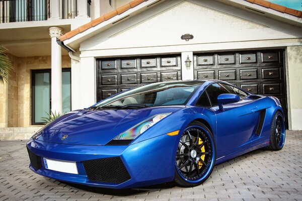 Blue lamborghini at a luxury villa