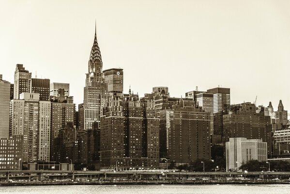 The sky is silver in New York. houses in manhattan