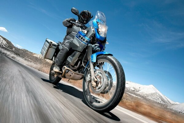 A man rides on a motorcycle on the road