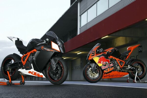 Motorcycles two KTM Red bull background garage