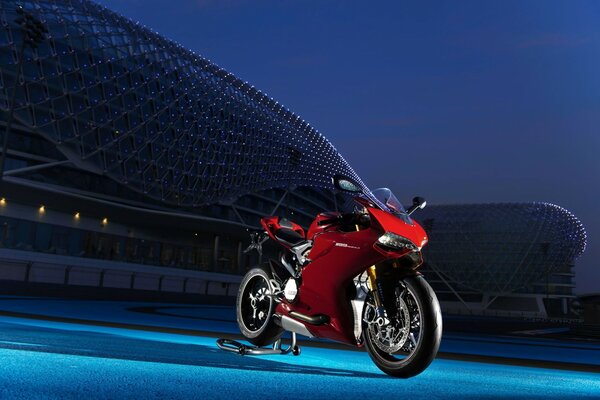 The red superbike is at the stadium