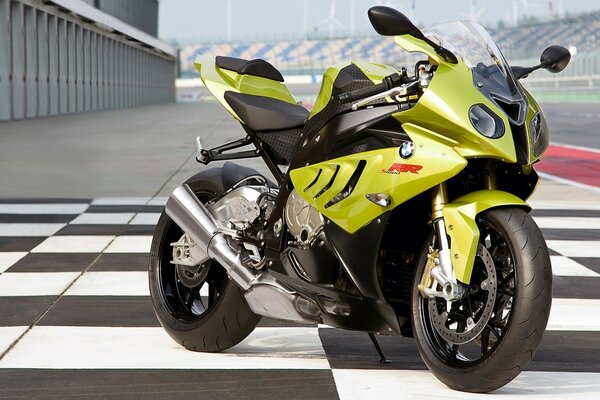 A BMW motorcycle stands on a black and white surface