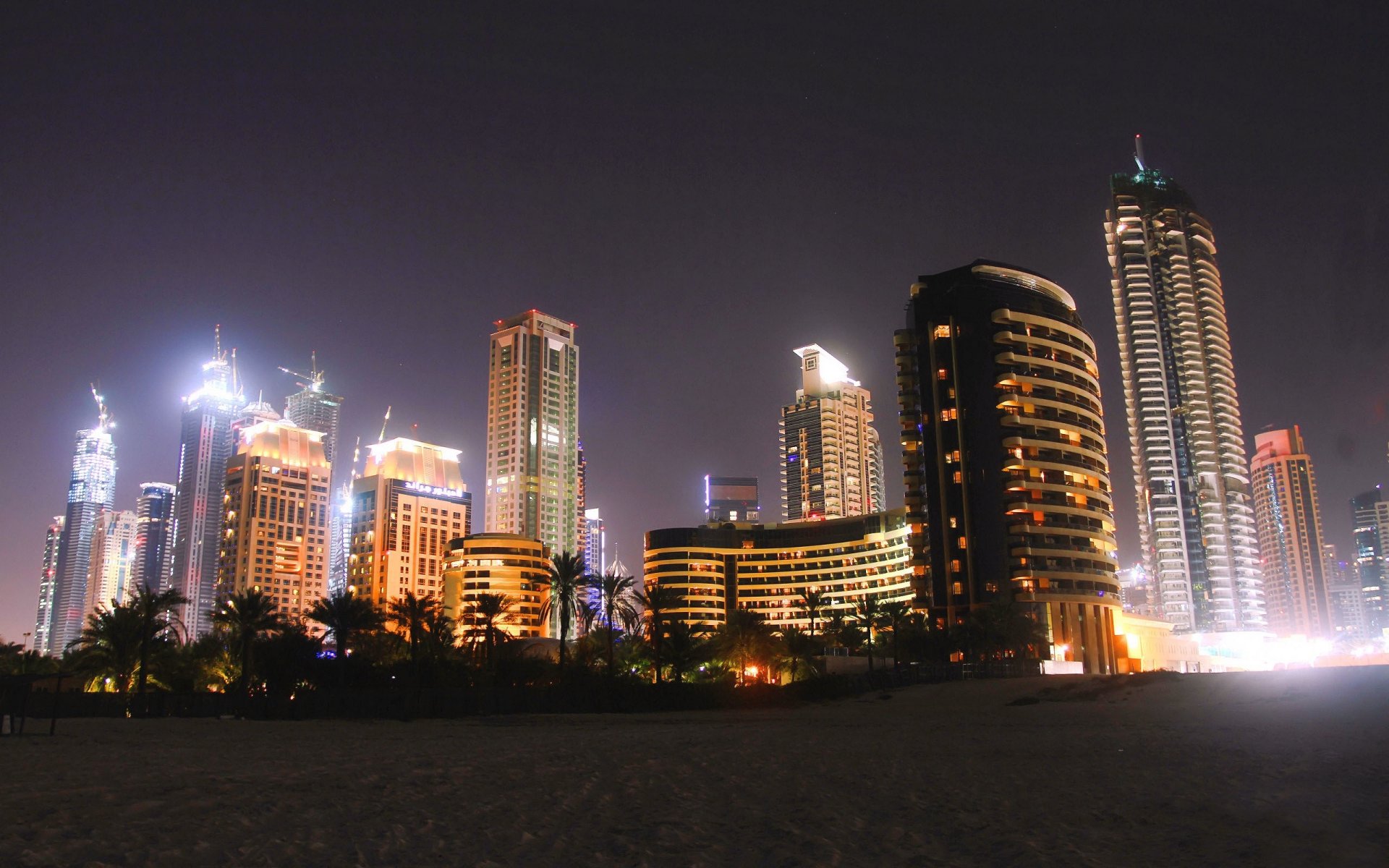 dubai stadt nacht vereinigte arabische emirate häuser hochhäuser palmen strand sand