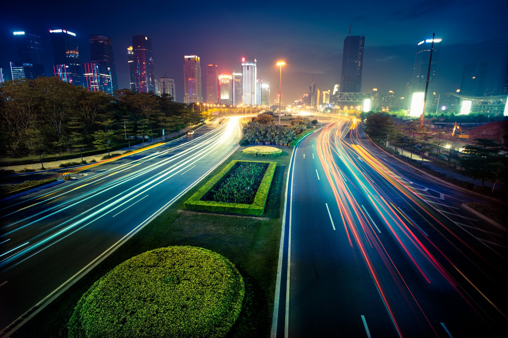 city lights street buildings blur trees town houses tree