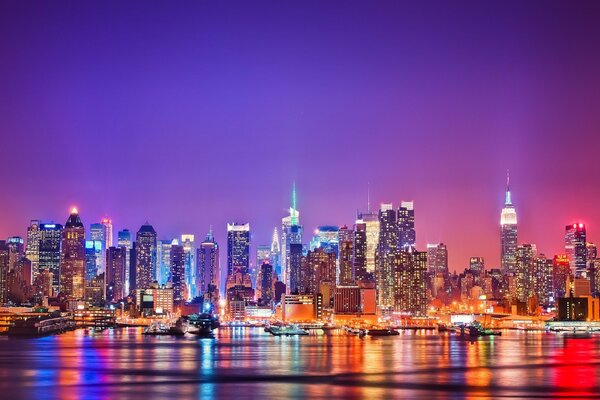 New York at night is reflected in the water