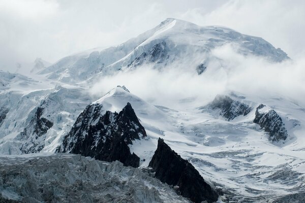 Der Gipfel eines schneebedeckten Berges im Nebel