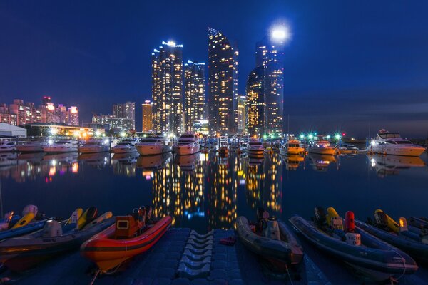 Night pier illuminated by the lights of skyscrapers