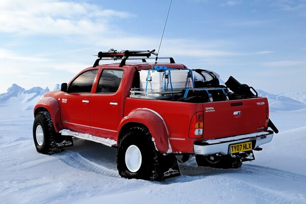 Мощный красный внедорожник toyota hilux на северном полюсе