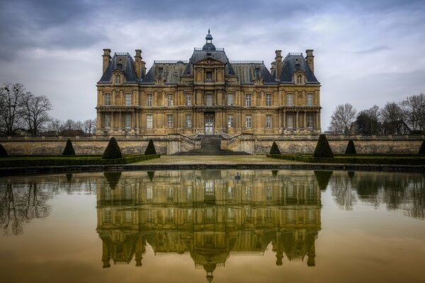 The castle reflected in the calm water