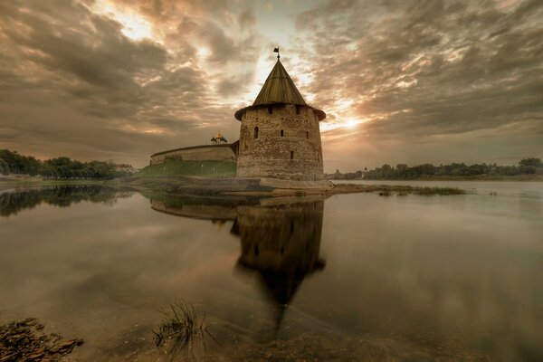 The dawn that is reflected in the water in autumn in Pskov