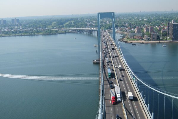 Cars drive across the bridge into the city