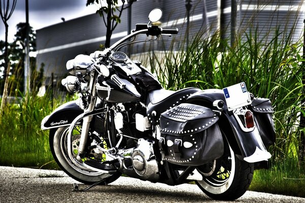 Title motorcycle standing on the background of a large house