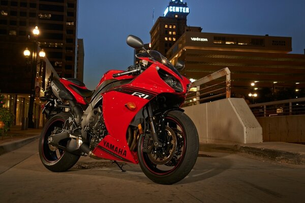 Red bike on the background of the night city